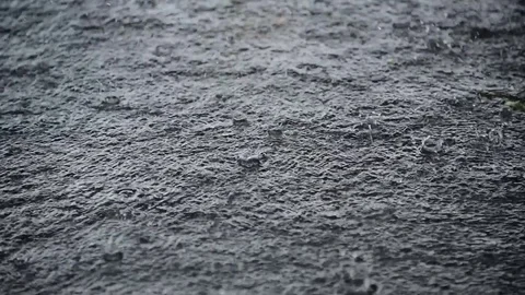 Rain pouring and flowing down splashing on concrete ground with sound Stock Footage 84933903