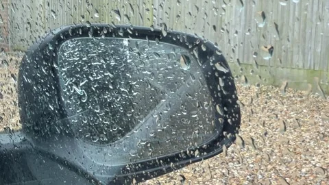 Rain pouring on car side mirror detail Stock Footage 331539853