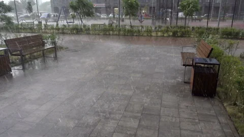 Rain pours down on benches in slow motion. Stock Footage 196081855