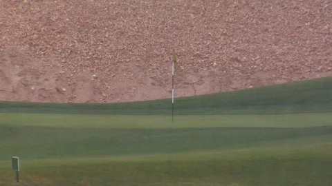 Rain pours down on desert golf course B Stock Footage 125344751