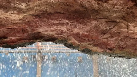 Rain pours down near the cave and the waterfall Stock Footage 277191028