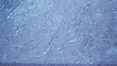 Rain pours down on section of cracked wind shield damaged by hail Stock Footage 104061506