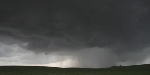 Rain pours from lowering dark clouds onto Nebraska plains Stock Footage 59334396