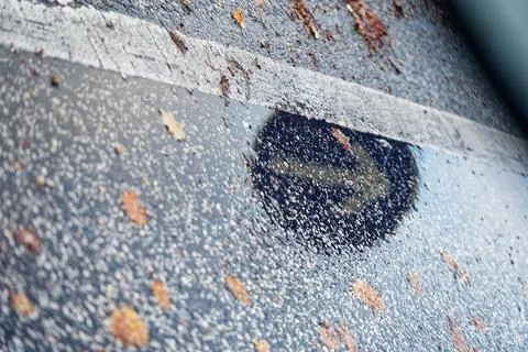 Rain puddle reflecting a right turn road direction sign Stock Photos