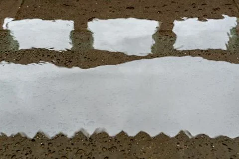 Rain Puddle Reflection on Wet Textured Surface Stock Photos