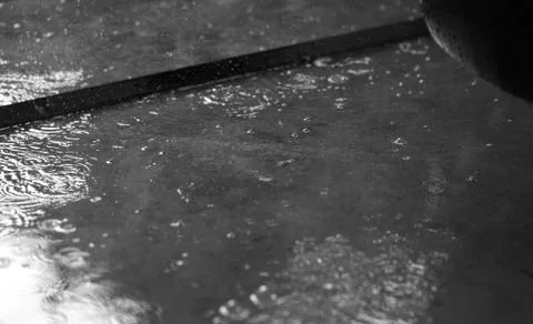 RAIN PUDDLES WITH RAINDROPS Stock Photos
