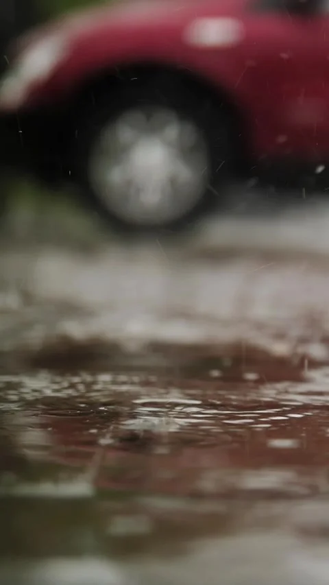 Rain, puddles. raining on parking lot. close-up. raindrops fall into puddles Stock Footage 313229569