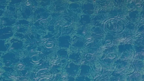Rain puring onto the swimming pool Stock Footage 346971850