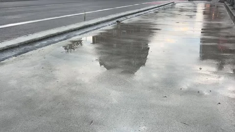 Rain Reflections on Wet Riverside Walkway Stock Footage 340443055