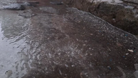 Rain Ripples and Splashes in a Murky Puddle Stock Footage 329207333