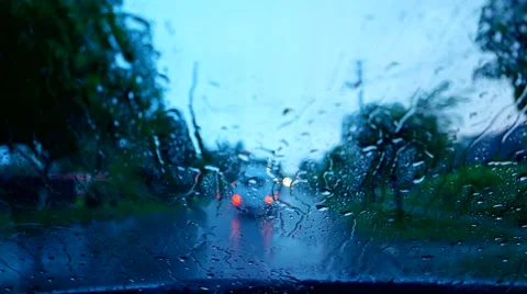 Rain on road , water flows on the windshield Stock Footage 50711021