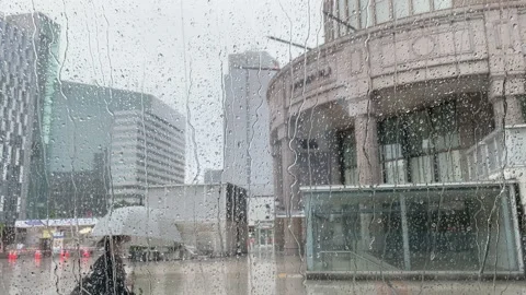 Rain Running Down a Big Window with a masked-woman passed by at Sapporo City Stock Footage 157848564