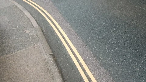 Rain running down the roadside gutter in a summer storm Stock Footage 283455758