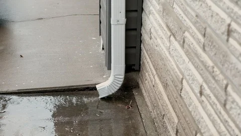 Rain running from white gutter Stock Footage 93949894