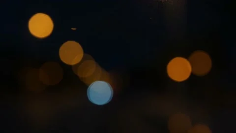 Rain seen through a car window at night with nice bokeh Video stock 164609357