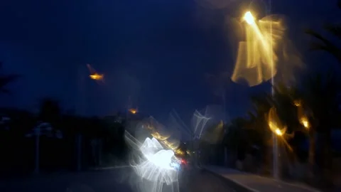 Rain seen through a car window at night with nice bokeh Stock Footage 164609364