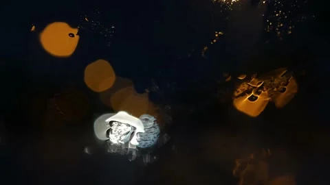 Rain seen through a car window at night with nice bokeh Stock Footage 164609374