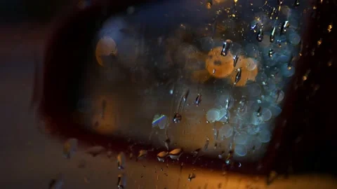 Rain seen through a car window at night with nice bokeh Stock Footage 164609400