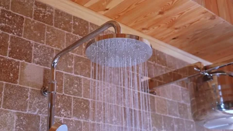 Rain shower in the bathroom. Silver shower in the bathroom with beige tiles Stock Footage 221997604
