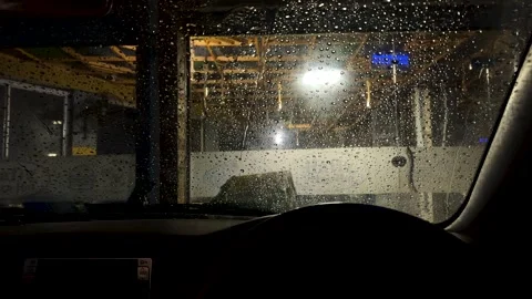 Rain shower on car windshield at night time. Stock Footage 326239894