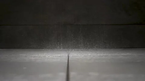 Rain shower droplets falling on a white bathroom floor Vidéo 266028271