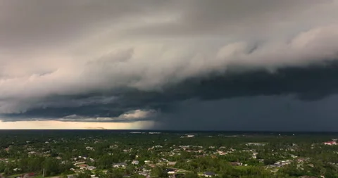 Rain shower water pouring down from stormy clouds during summer thunderstorm in Stock Footage 329142737