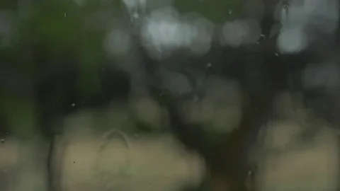 Rain sliding down a window during a storm (Closeup) Stock Footage 77553882