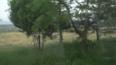 Rain sliding down a window (Midshot) Stock Footage 76720300