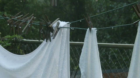 Rain soaked laundry pull Stock Footage 702013