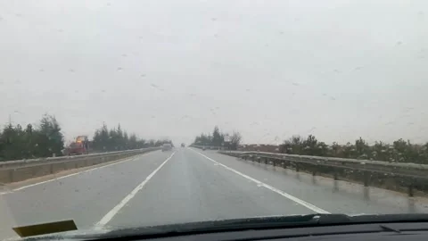 Rain-soaked road view through car windshield with wipers in heavy storm Stock Footage 327967021