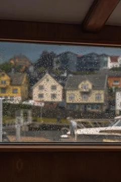 Rain Speckled Window View of a Harbor Town in Norway Stock Photos