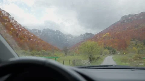Rain speckled windshield view of a Balkan mountain valley drive Stock Footage 329412275