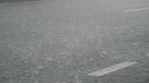 Rain splashes hit the asphalt during extreme bad weather precipitations. Stock Footage 295774965