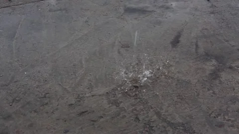 Rain splashes hit the asphalt, heavy rain, close-up. Stock Footage 168964542