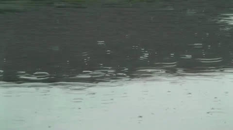Rain splashes on the pavement or tarmac. Stock Footage 22260975