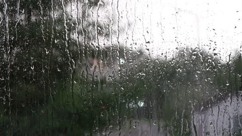 Rain is splashing against a window Stock Footage 78574365