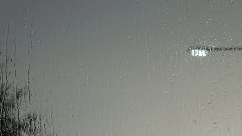 Rain is splashing against a window Stock Footage 78590927