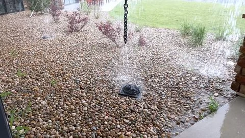 Rain Splashing into Pebble Drainage Bed Stock Photos