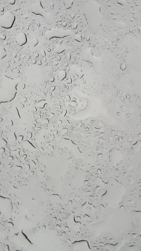 Rain splatter patterns on glass: dynamic movement of water droplets Stock Footage 320851405
