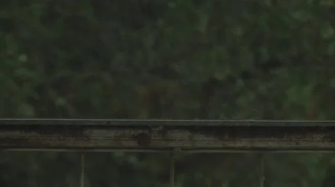 Rain splattering on metal railing Stock Footage 57360241