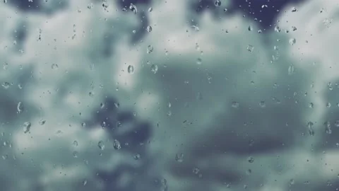 The rain stops. Dark clouds give way to light white clouds and blue skies. Rapid Stock Footage 239637326