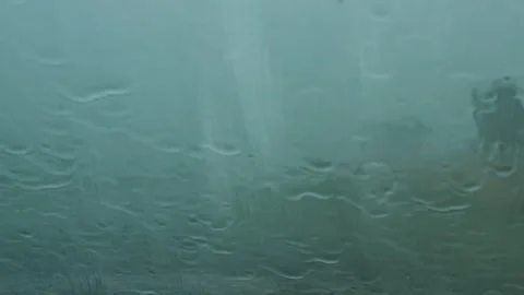 Rain storm drops on the windshield of a parked car close up Stock Footage 345619686