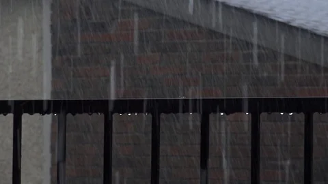Rain storm on porch dripping down railing and big wind gusts Stock Footage 76326542