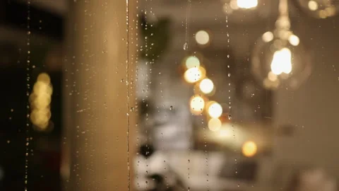 Rain-streaked pane, Blurred rain, Raindrop lights Stock Footage 340664292