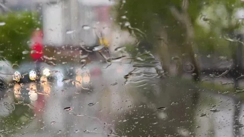 Rain streaming down glass, blurring urban traffic landscape Stock-Footage 310335151