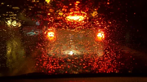 The rain streams on the front window of the windshield window of the car stop Stock Footage 83858985