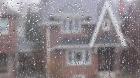 Rain on suburban window. Defocused house. Stock Footage