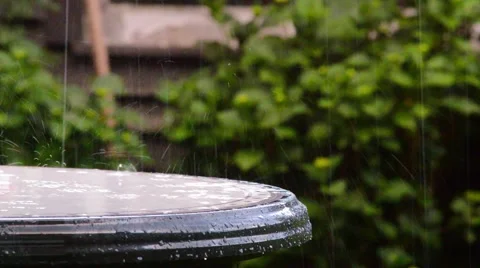 Rain on a table in a garden Stock Footage