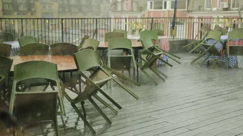 Rain on the terrace of a cafe, view from the window, the restaurant is closed Stock Footage 318066665