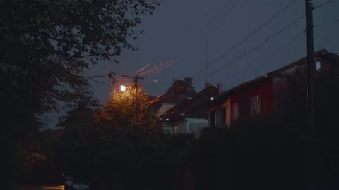 Rain with thunder and lightning in the evening on a street with houses and ta Stock Footage 82312644